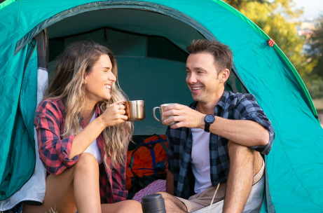 cheerful-couple-sitting-tent-chatting-drinking-tea-pt 1